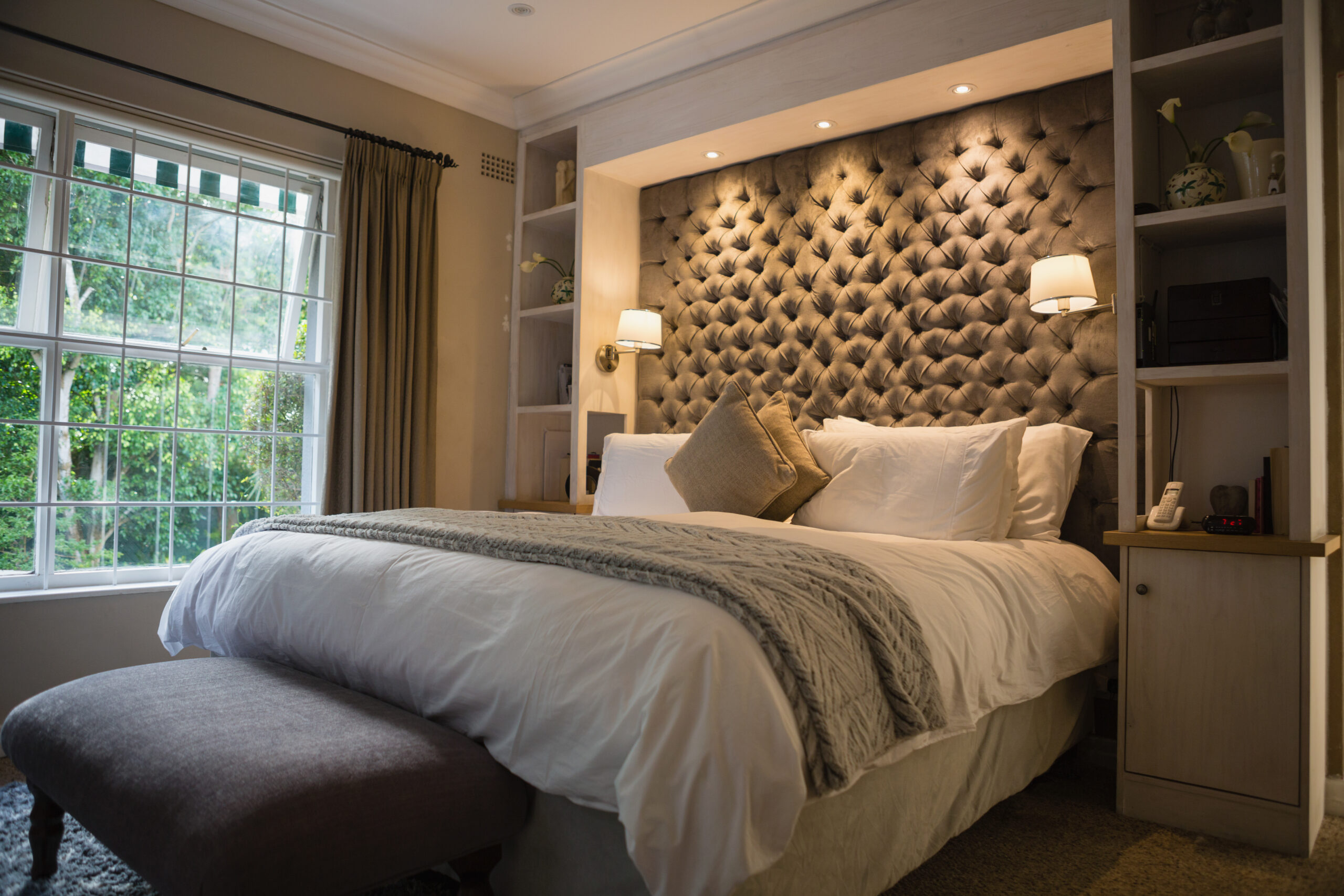 A stylish Denver bedroom with soft accent lighting, bedside table lamps, and a sleek ceiling fixture for a relaxing ambiance.